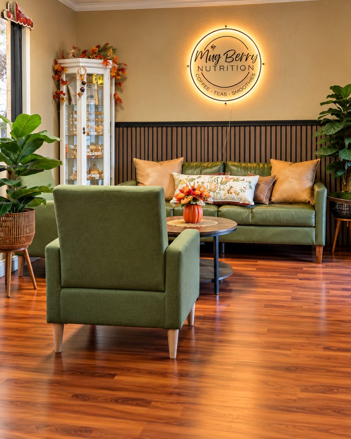 The Mug Berry lounge with green chairs and glowing logo